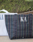 Two tote bags with 'KA' monogram on a neutral background