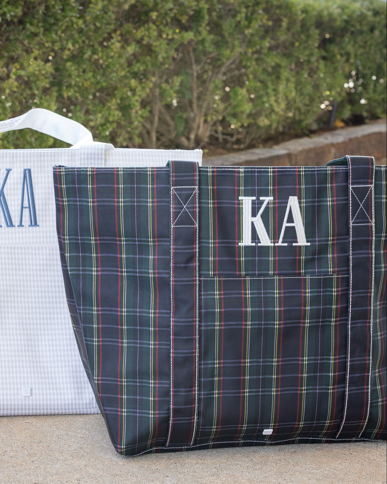Two tote bags with 'KA' monogram on a neutral background